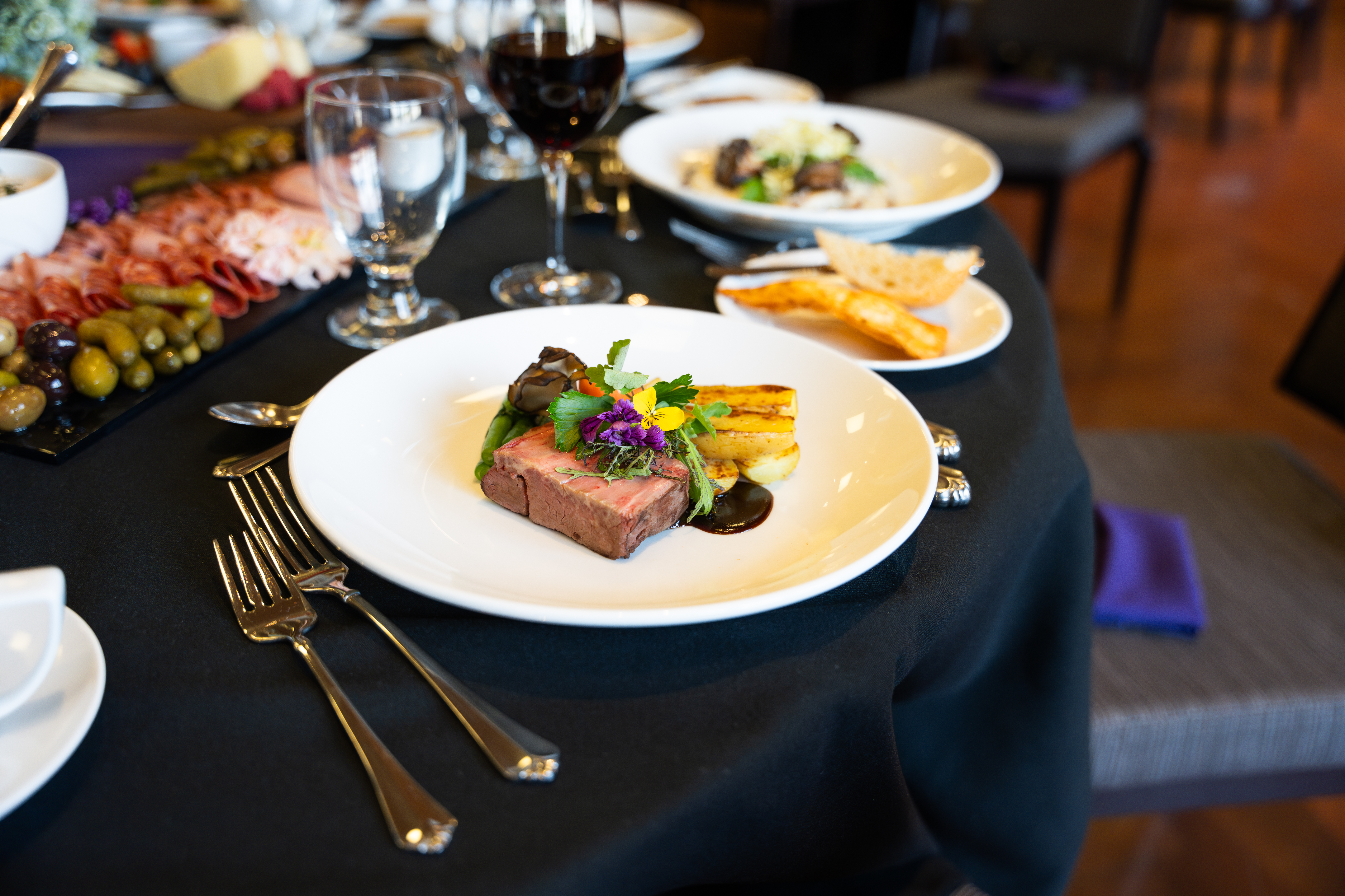 A plated dish featuring steak on a table